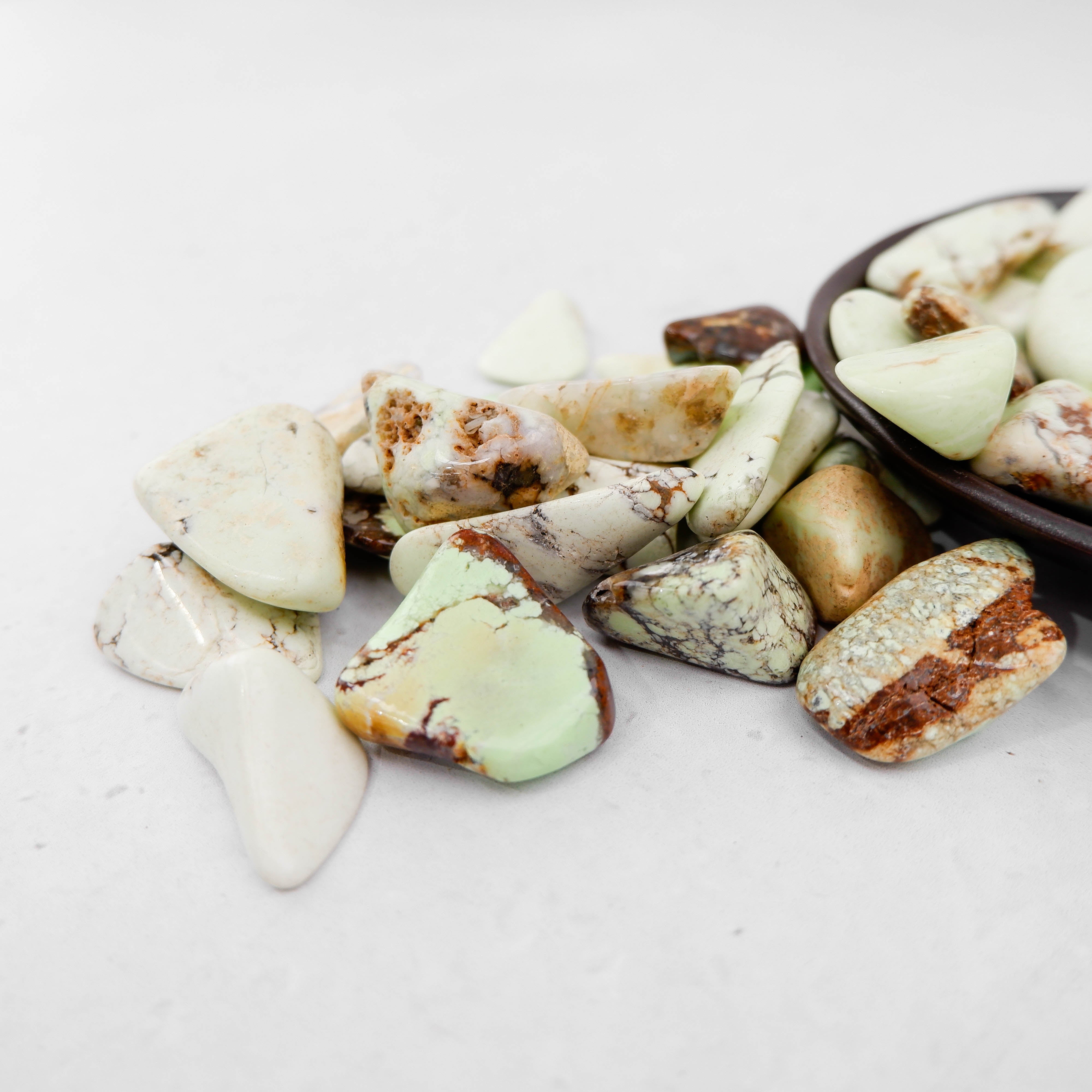 Lemon Chrysoprase tumble stone from Noctis Studio showing a smooth, polished green gemstone with vibrant lemon-yellow hues.