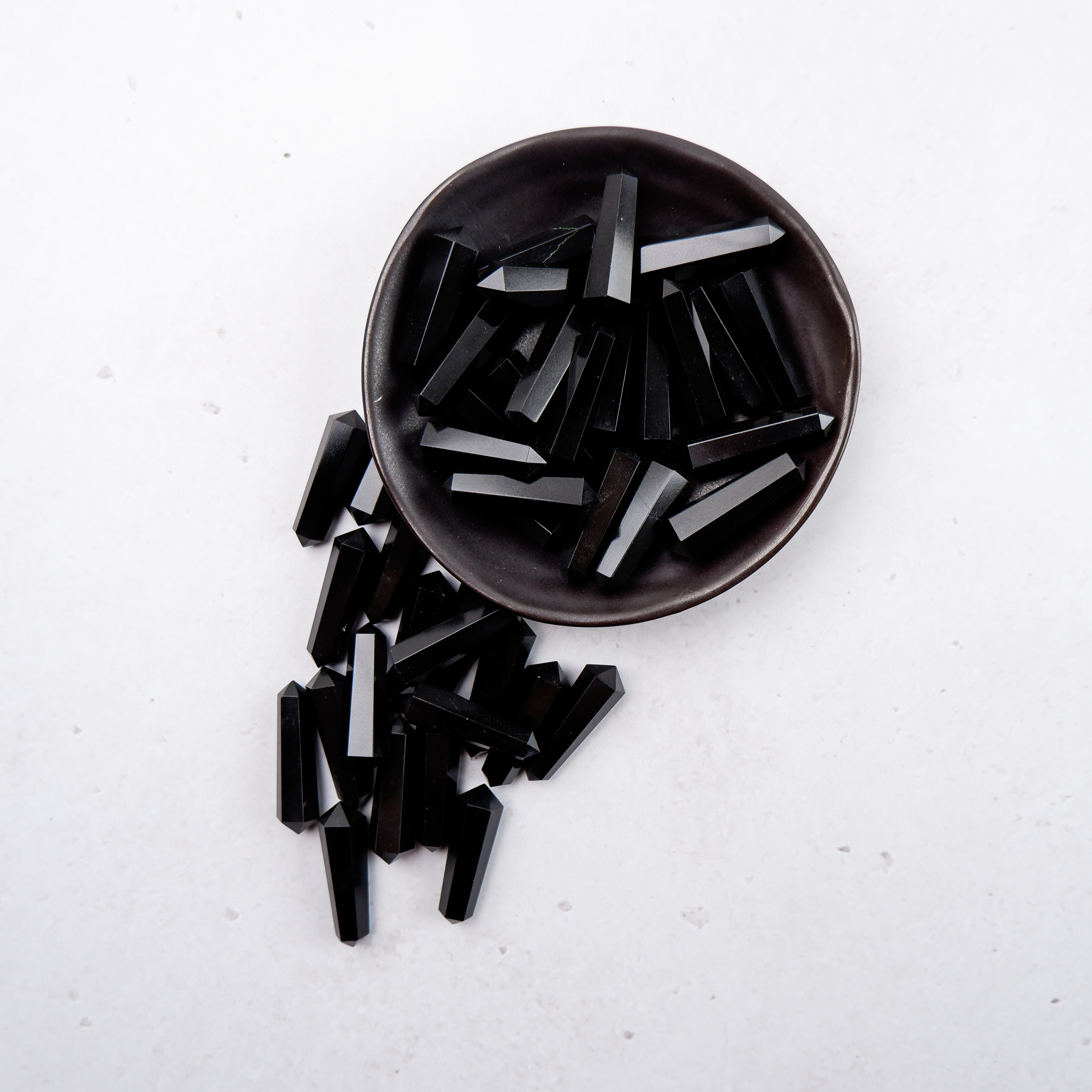 Black Jasper Double Gridding Point from Noctis Studio, featuring detailed craftsmanship and a sleek, polished surface for artistic use.