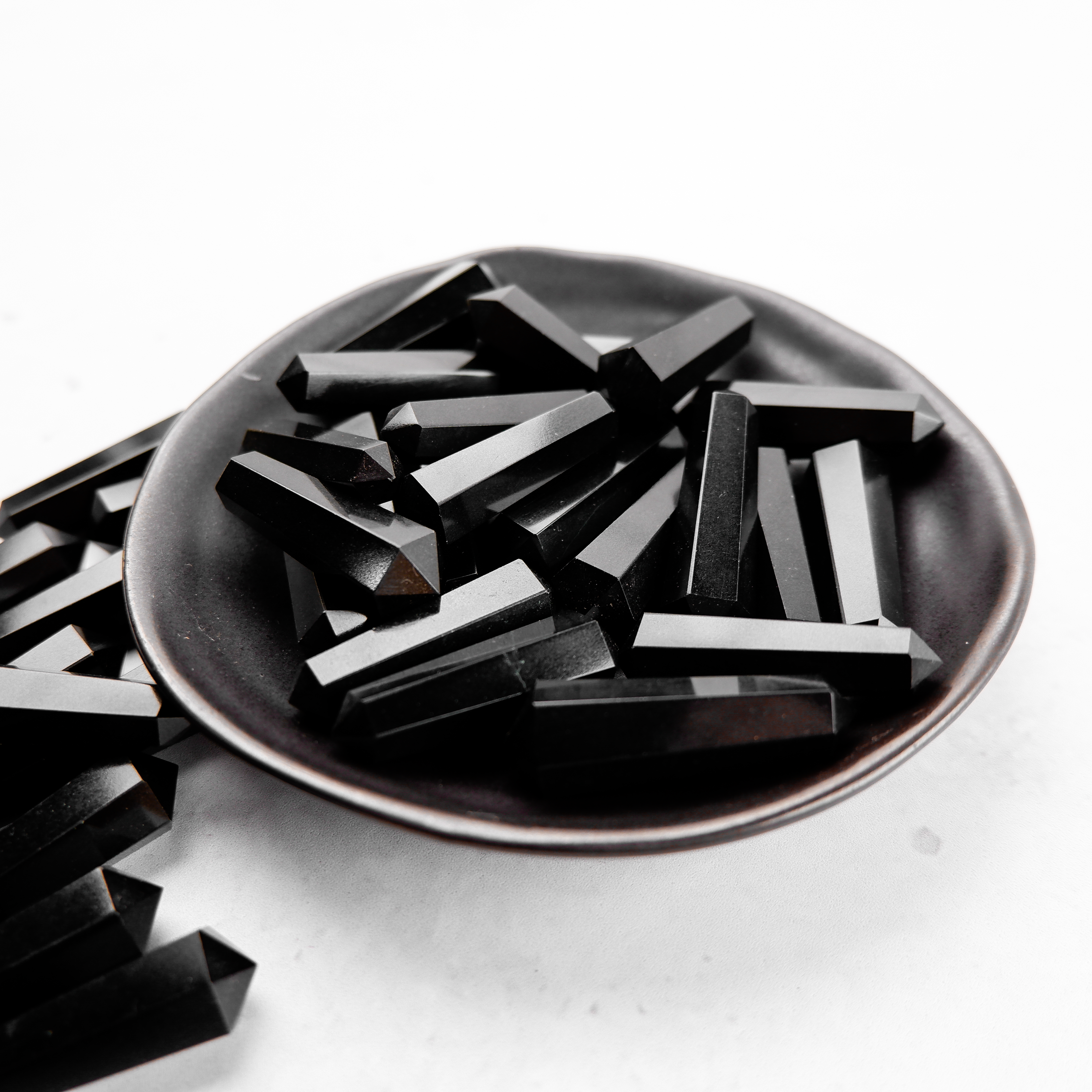 Black Jasper Double Gridding Point by Noctis Studio, featuring a polished black jasper stone with detailed double-sided gridding tips.