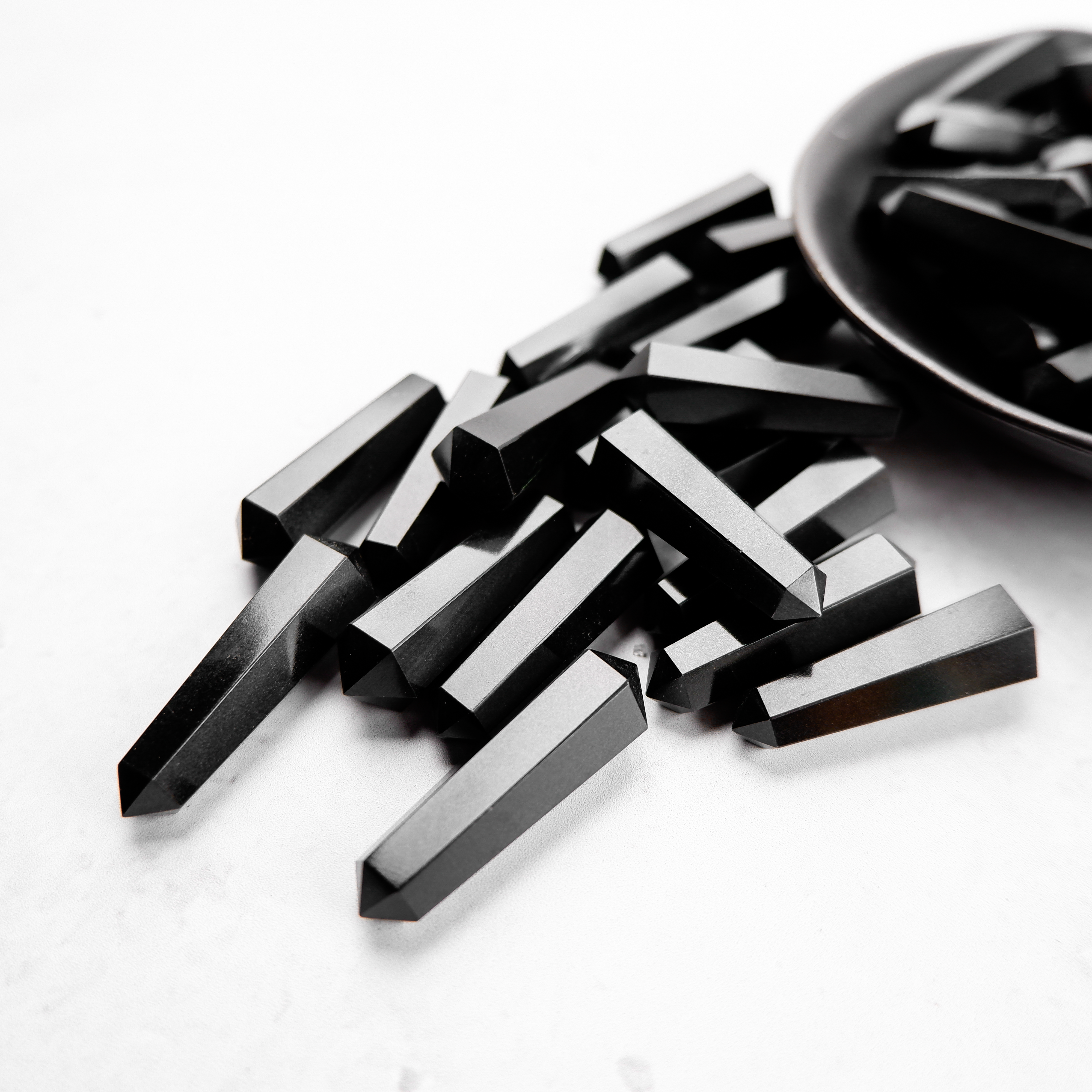 Black Jasper Double Gridding Point from Noctis Studio, featuring a polished black jasper stone with double pointed ends.