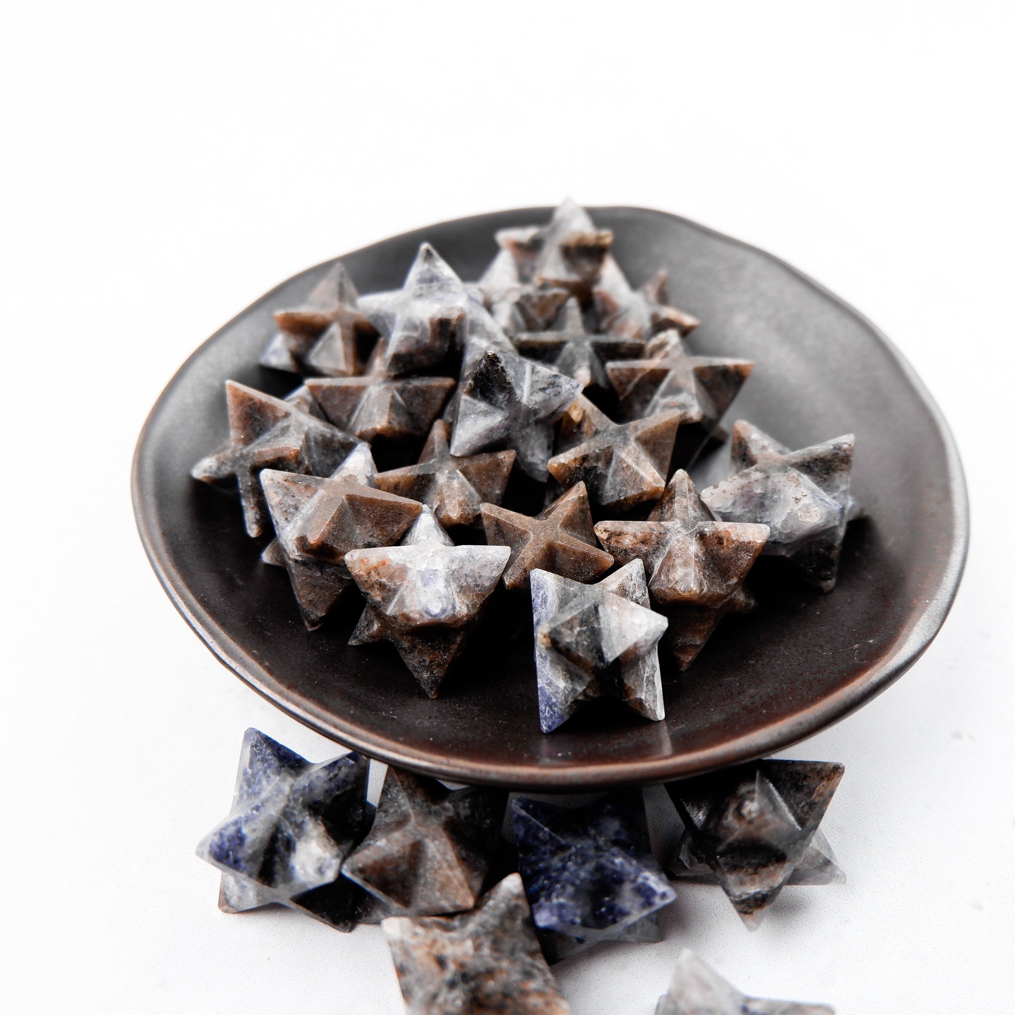 Iolite Star gemstone from Noctis Studio, showcasing a polished star-shaped Iolite with vibrant blue-purple hues.