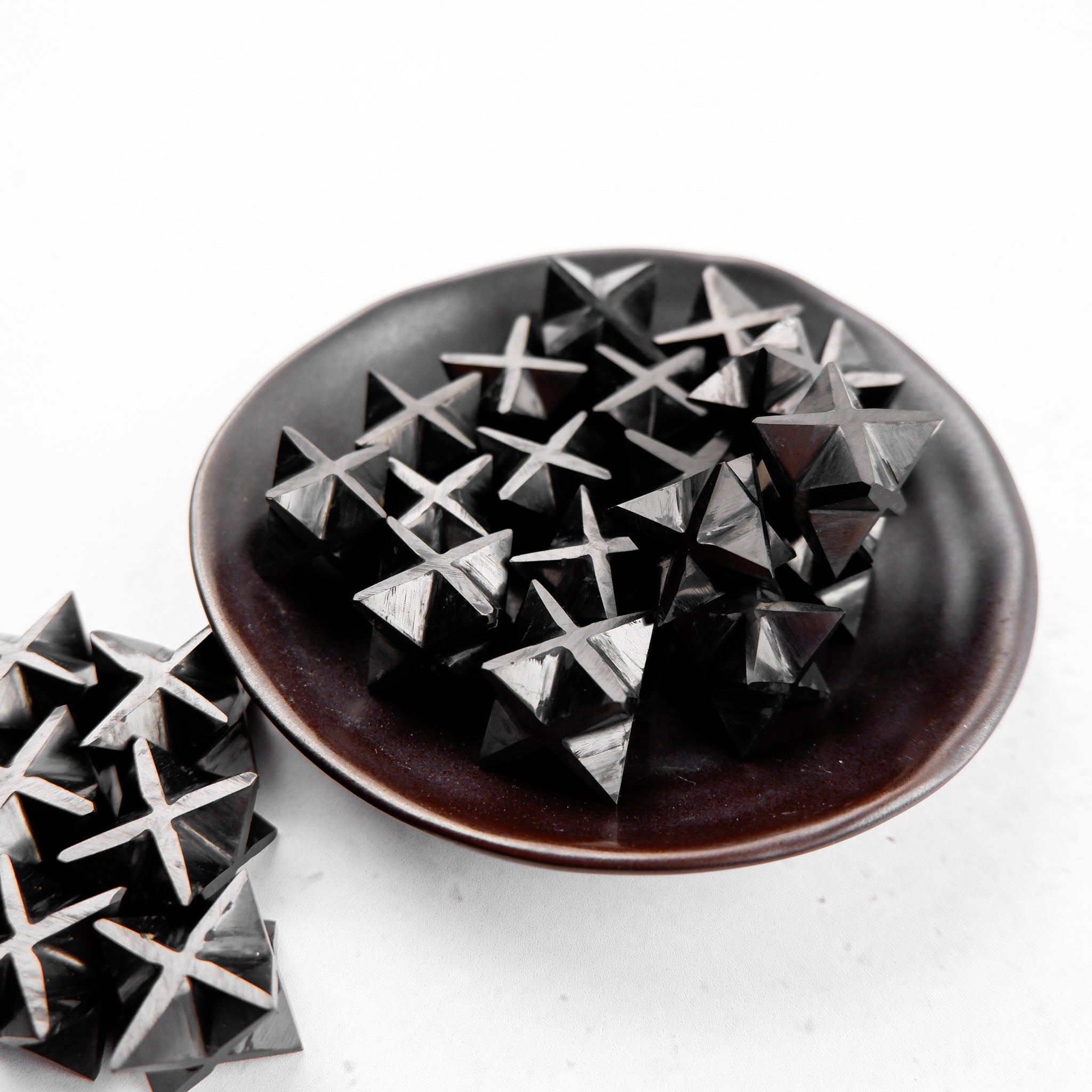 Shungite star crystal from Noctis Studio with a dark, polished star shape and natural mineral texture visible in the image.