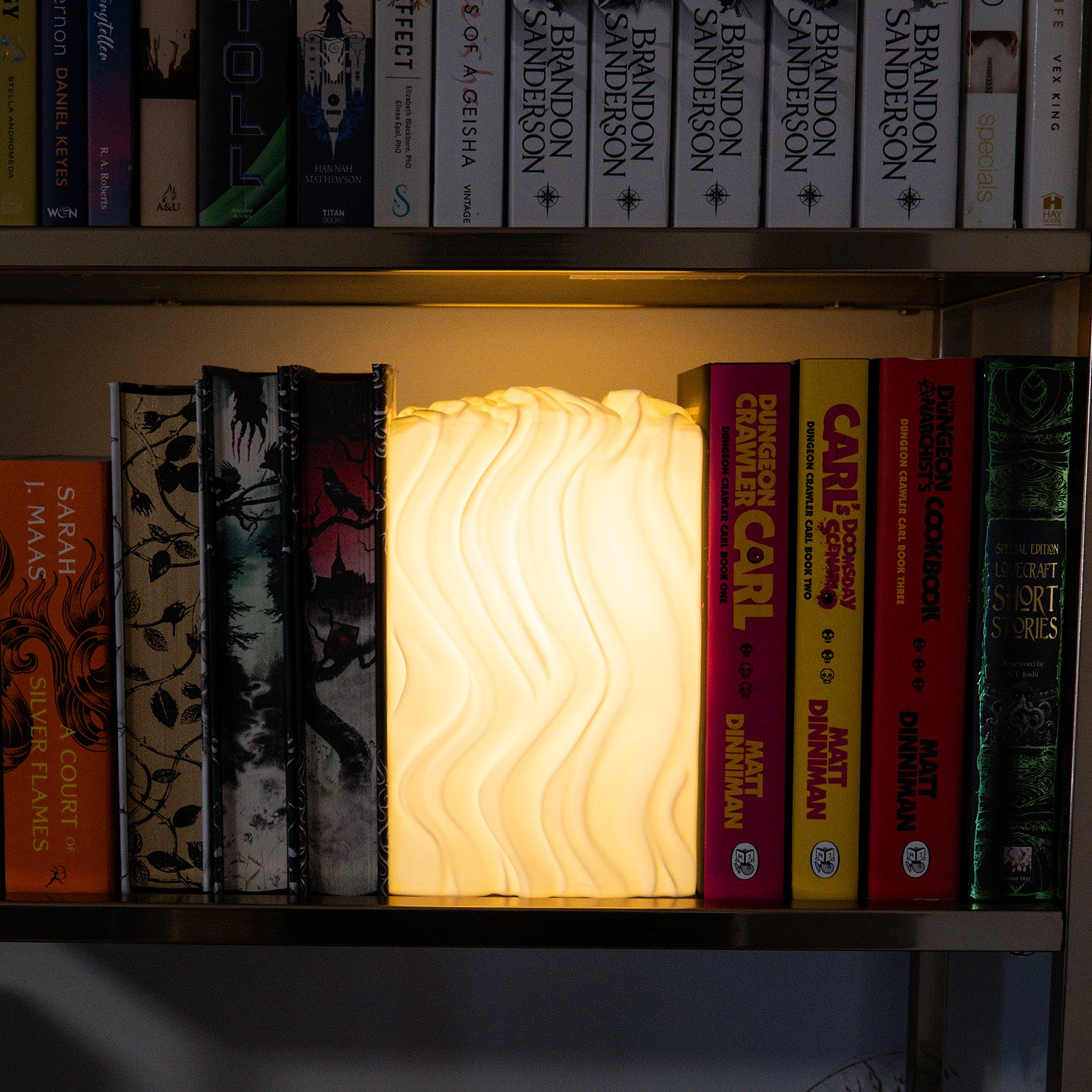 Noctis Studio Parallax Lamp with intricate geometric design and sleek metal finish, illuminated with warm ambient light.