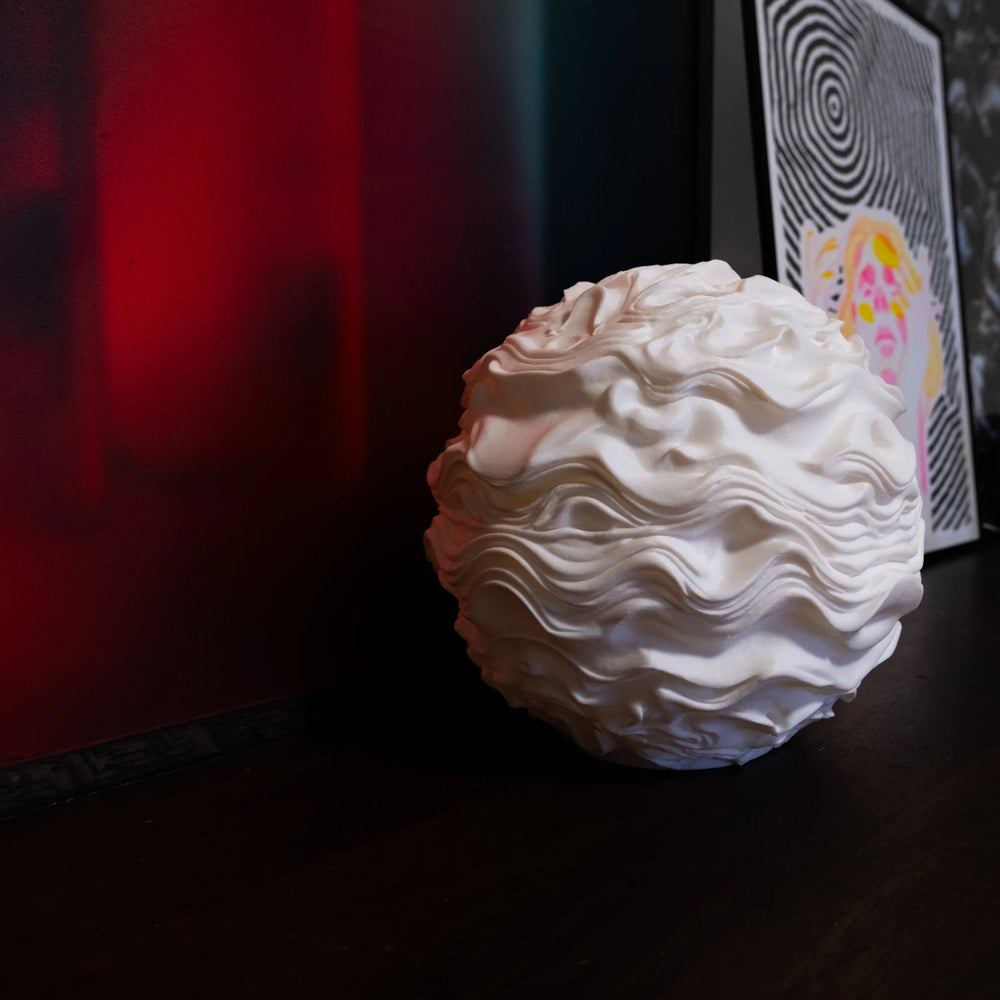 Close-up of the Noctis Studio Syzygy Lamp showcasing its sleek surface and modern design details.