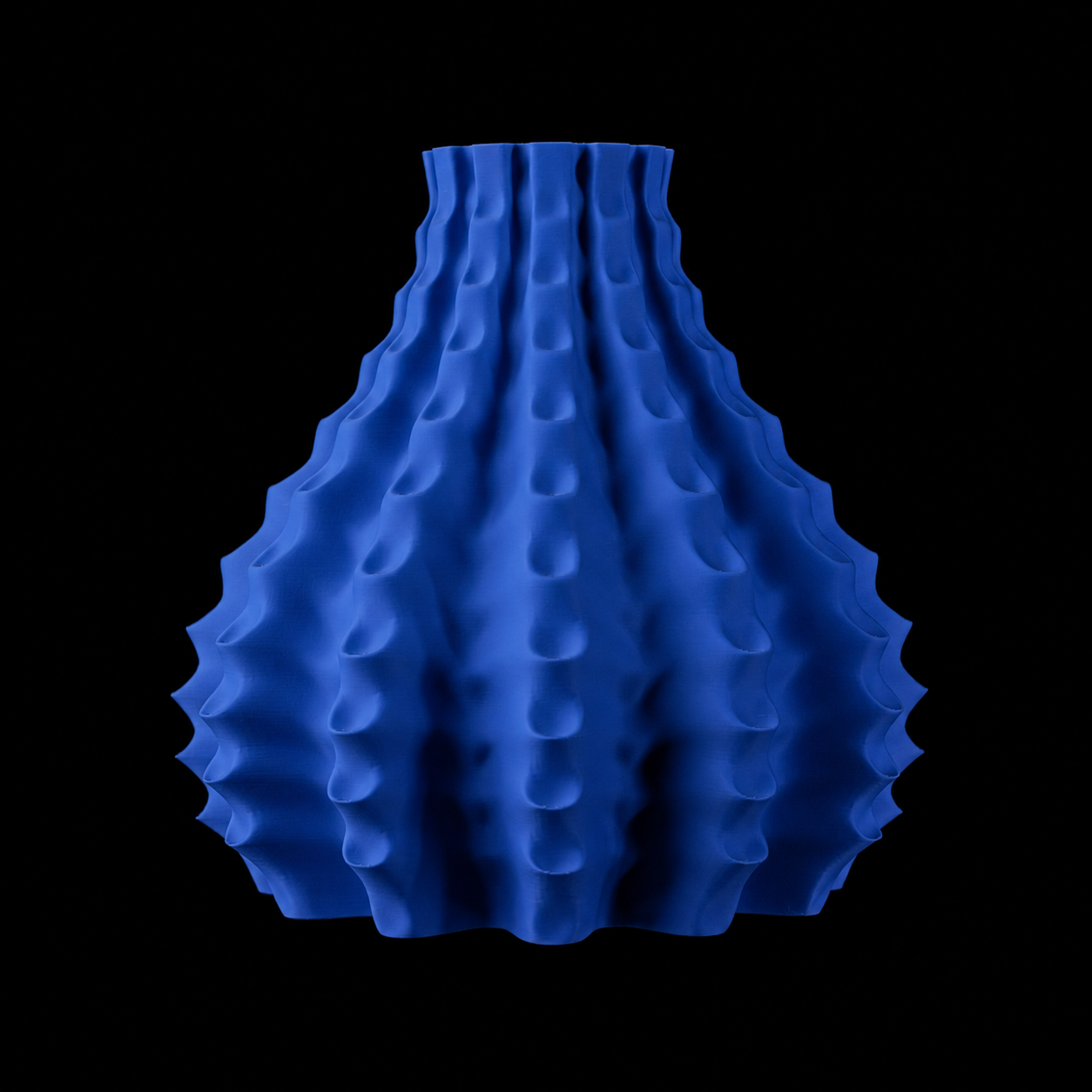Modern Machine Rippleform Vase with a textured, ripple pattern in ceramic, showcasing its elegant curved design.